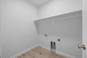 Laundry area featuring washer hookup, light wood finished floors, and electric dryer hookup