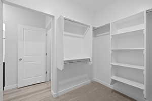 View of primary walk in closet