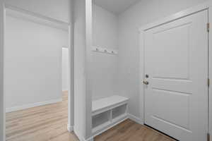Mudroom featuring wood finished floors and baseboards
