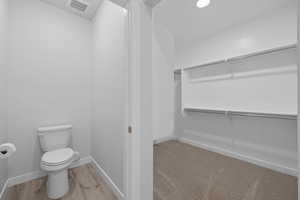 Walk in closet featuring wood finished floors