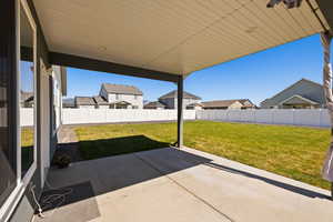 Fenced backyard featuring a patio and a residential view
