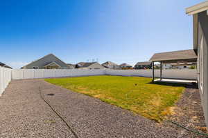 Fenced backyard with a patio area and a residential view