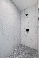 Bathroom featuring a tile shower