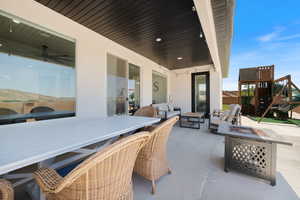 View of patio with an outdoor fire pit