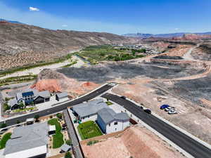 Aerial view of property and surrounding area with a mountainous background