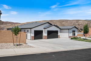 Single story home with a garage, driveway, a mountain view, a tiled roof, and stucco siding