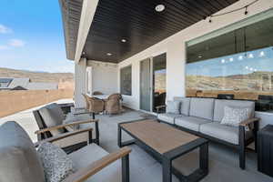 View of patio featuring an outdoor living space and a mountain view