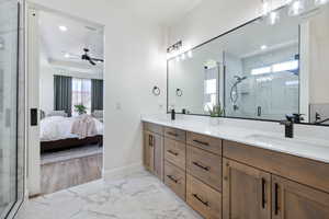 Ensuite bathroom with double vanity, a marble finish shower, marble look tile flooring, ceiling fan, and recessed lighting