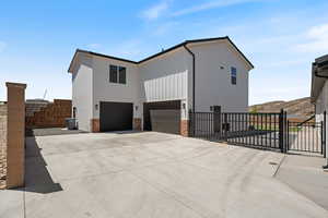 View of home's exterior with an attached garage, concrete driveway, board and batten siding, brick siding, and a mountain view