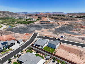 Aerial view of property and surrounding area with a mountain backdrop