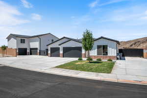 Modern farmhouse style home with driveway, a garage, and board and batten siding
