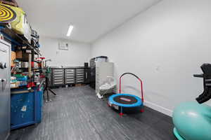 Game room with a wall unit AC and baseboards