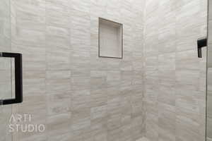 Bathroom featuring tiled shower