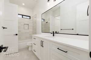 Bathroom with vanity, washtub / shower combination, and recessed lighting