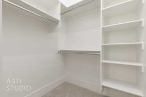 Spacious closet featuring carpet flooring