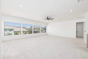 Spare room featuring light carpet, recessed lighting, and a ceiling fan