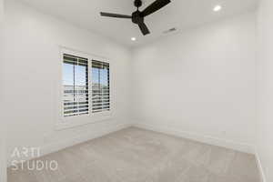 Empty room featuring carpet flooring, a ceiling fan, and recessed lighting