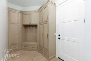 Mudroom with light wood-style flooring