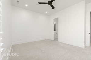 Empty room featuring a ceiling fan, light colored carpet, and recessed lighting