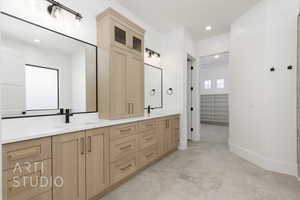 Bathroom featuring double vanity, a closet, and recessed lighting