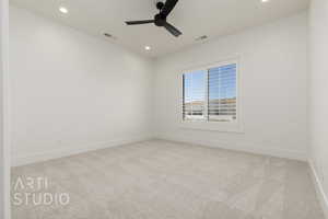 Empty room featuring carpet, ceiling fan, and recessed lighting