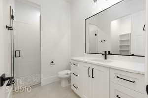 Bathroom featuring vanity, a stall shower, and tile patterned flooring