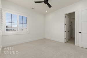 Carpeted empty room featuring ceiling fan and recessed lighting