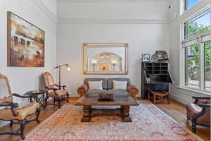 Living area featuring wood finished floors and crown molding