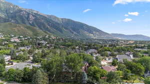 View of mountain backdrop featuring nearby suburban area