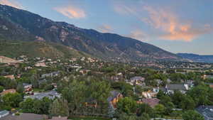 Aerial view of property's location featuring a mountain backdrop and nearby suburban area