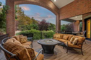 Patio terrace at dusk featuring an outdoor living space with a fire pit and a wooden deck