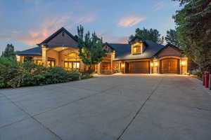 View of front of house featuring brick siding, concrete driveway, and an attached garage