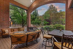 Wooden deck featuring an outdoor living space and outdoor dining area