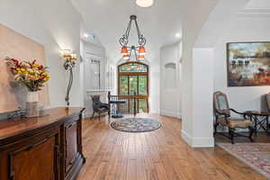 Entryway with light wood finished floors, lofted ceiling, and recessed lighting