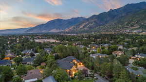 Aerial overview of property's location featuring a mountainous background and nearby suburban area