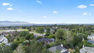 Aerial view of property's location featuring nearby suburban area and a mountain backdrop
