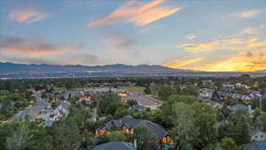 Aerial overview of property's location featuring mountains and nearby suburban area