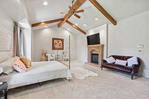 Bedroom featuring recessed lighting, carpet, and a glass covered fireplace