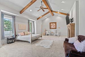 Carpeted bedroom featuring recessed lighting and a fireplace