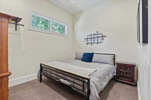 Carpeted bedroom featuring baseboards