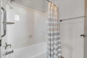 Bathroom featuring shower / bath combo with shower curtain