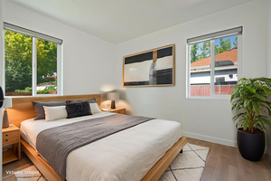 Bedroom featuring multiple windows and wood finished floors