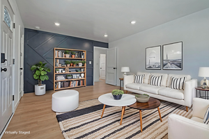 Living room featuring light wood-style flooring and recessed lighting
