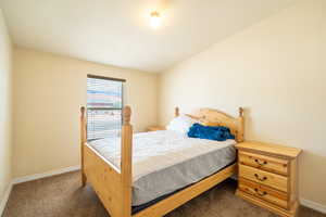 Carpeted bedroom featuring baseboards