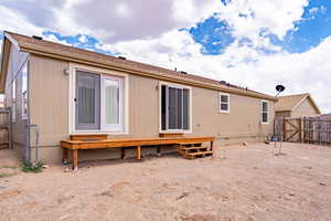 Rear view of house with a deck and crawl space