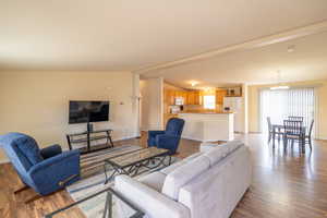 Living area with wood finished floors and a chandelier