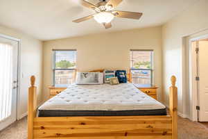 Bedroom featuring light colored carpet and a ceiling fan