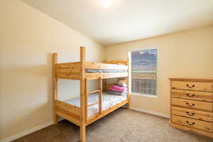 Bedroom featuring carpet flooring and baseboards