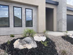 Doorway to property with stucco siding