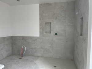 Bathroom featuring a tile shower